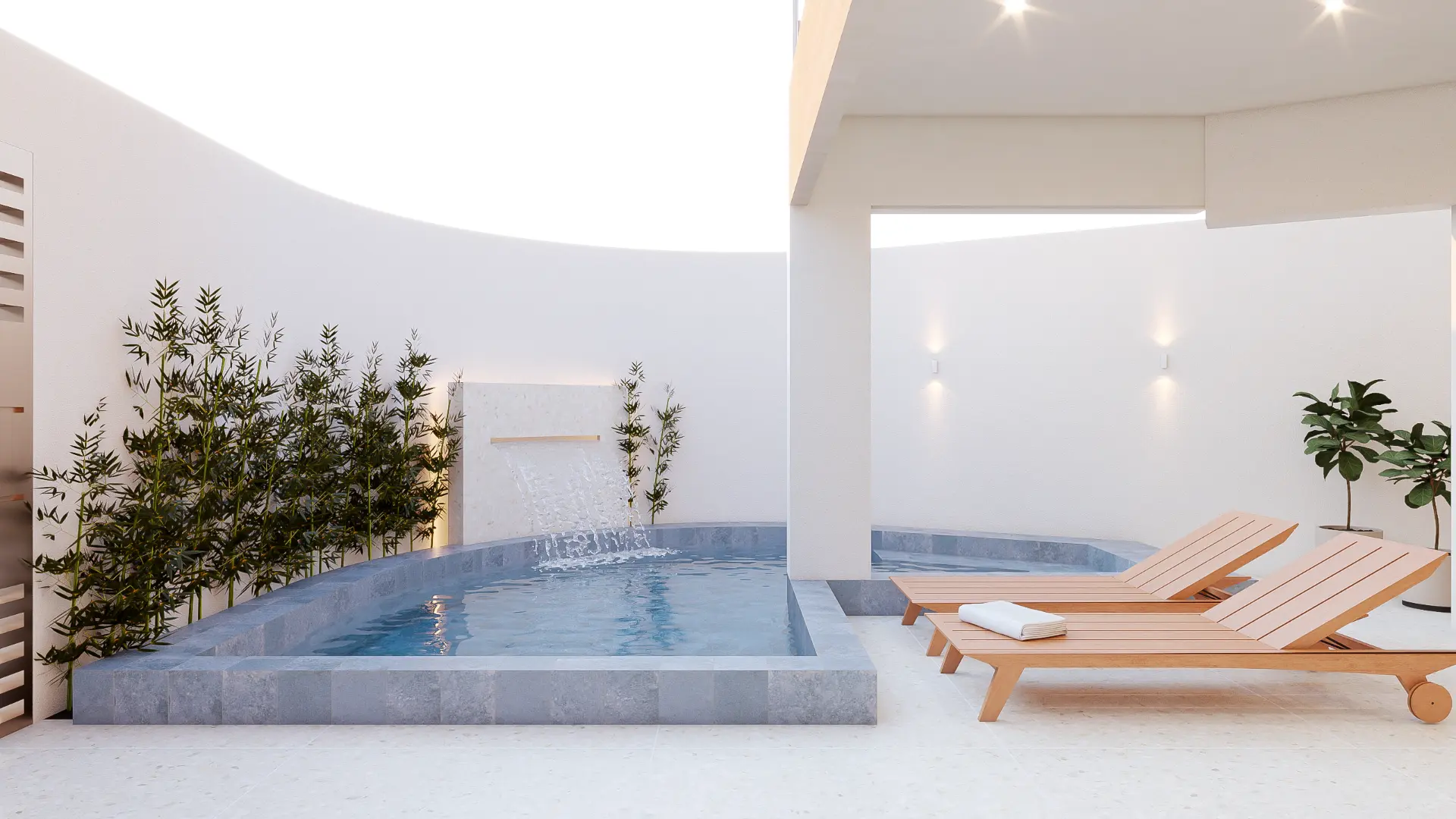 Piscina com cascata e deck com espreguiçadeiras